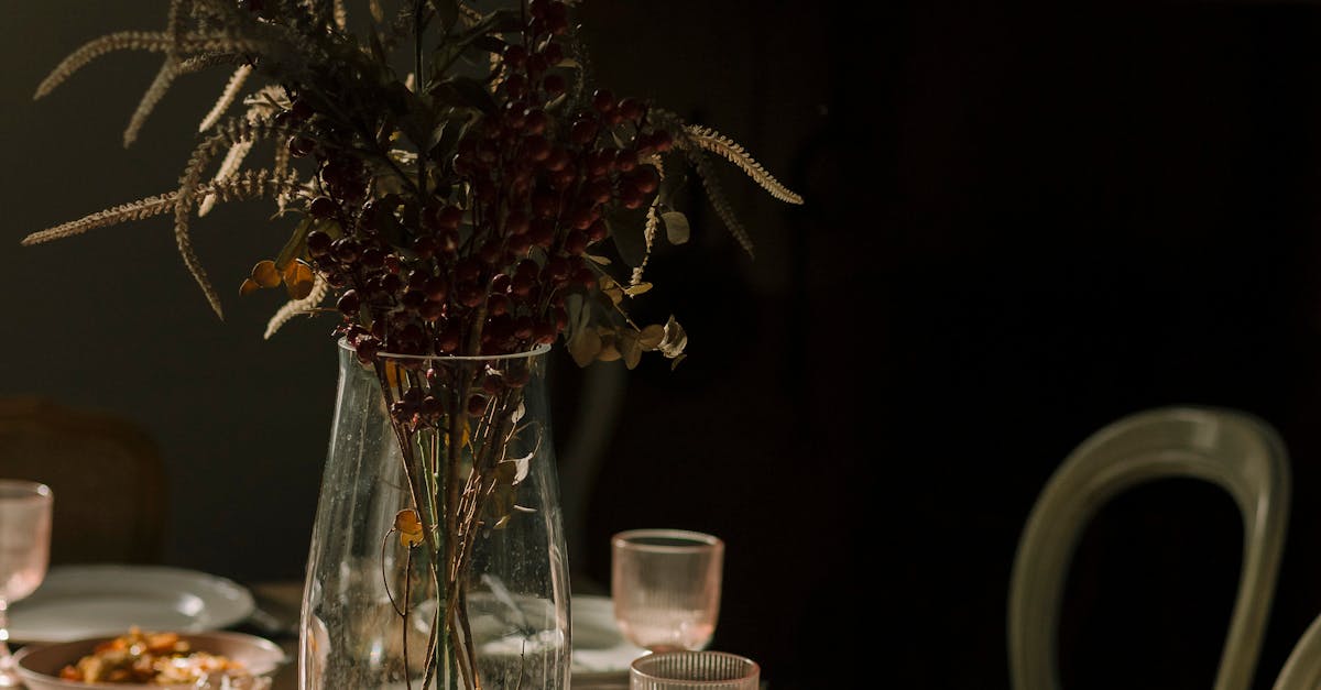 Brass candelabra, dried wheat, and crystal glassware on a walnut table